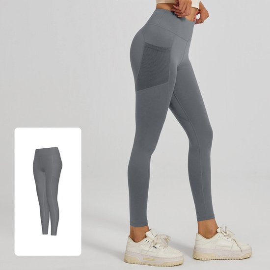 Gray leggings with a pocket detail worn by a person on a white background