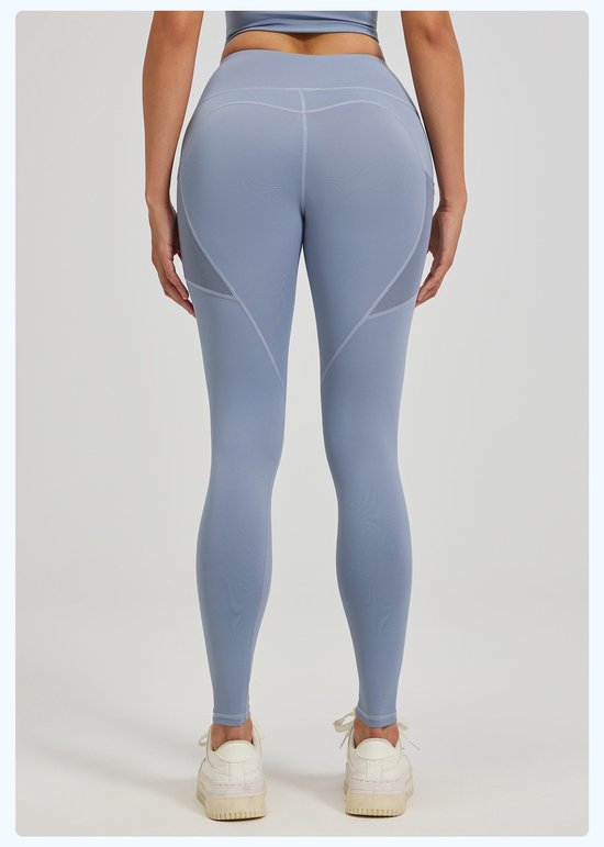Person wearing light blue leggings on a plain background
