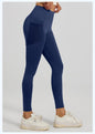 Navy blue leggings with pockets worn by a person on a light gray background