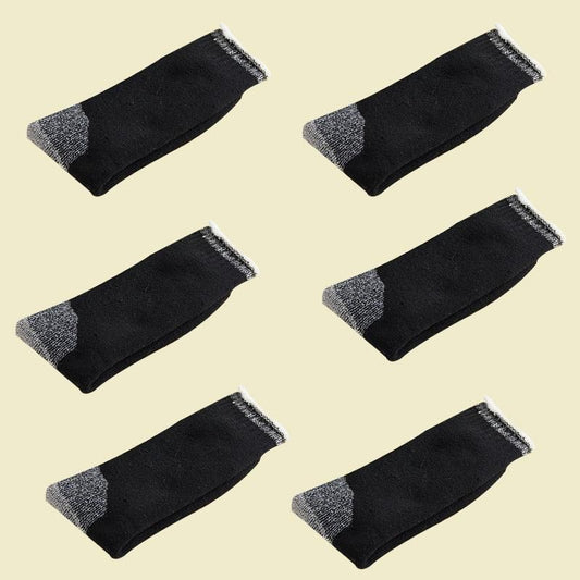 Six pairs of black socks with gray accents on a beige background