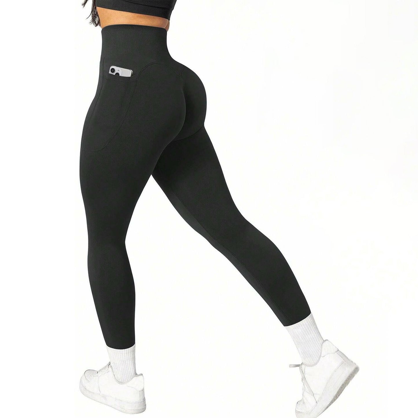 Black leggings with a pocket detail worn by a person on a white background