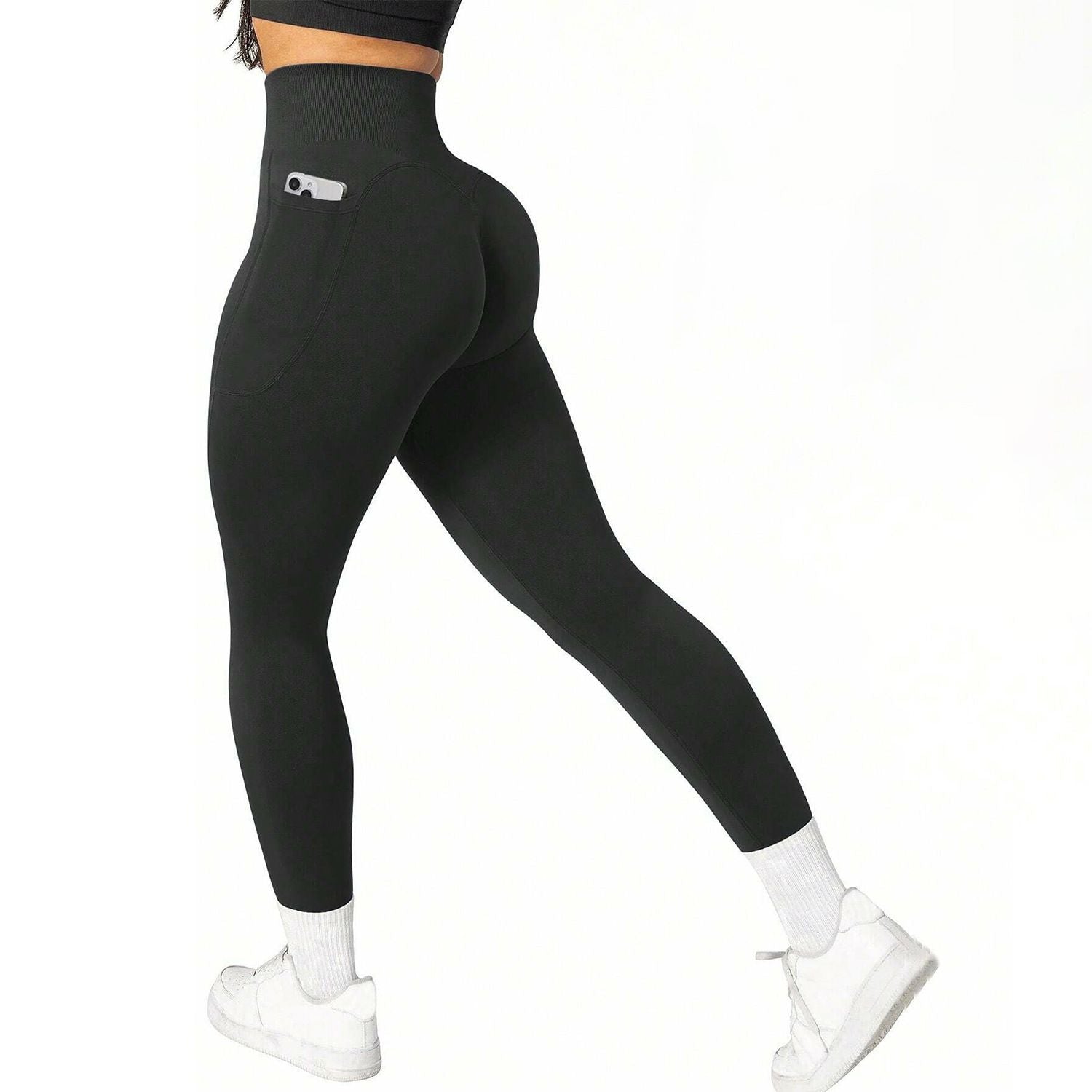Black leggings with a pocket detail worn by a person on a white background