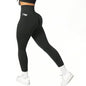 Black leggings with a pocket detail worn by a person on a white background