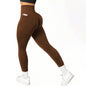 Coffee leggings worn by a person on a white background